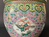 a colorful vase with a painting on it on a table