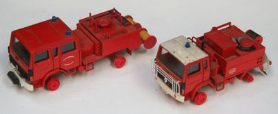 deux camions de pompiers miniatures posés côte à côte sur une surface blanche