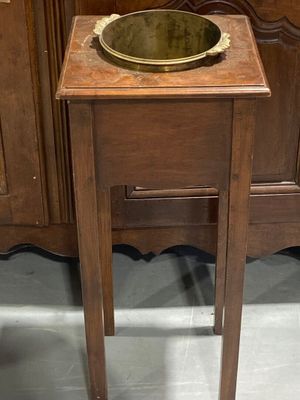 a small wooden table with a bowl on top of it