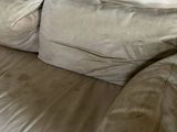 a couch that has two pillows on it in a living room