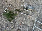 a broken cell phone sitting on the ground next to a ladder