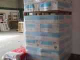 a stack of boxes sitting on top of a pallet in a warehouse