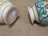 two salt and pepper shakers sitting on a table