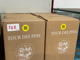 three boxes of tour des pins on a shelf in a store