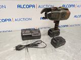a corded drill with two batteries and a charger