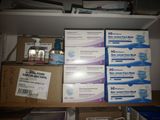 many boxes of medicine and other medical supplies on a shelf