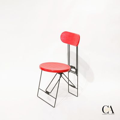 une chaise rouge posée sur une surface blanche