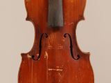 an old violin with a bow hanging from it ' s back