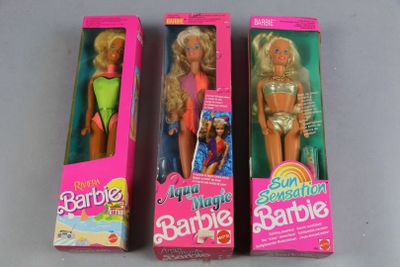 three barbie dolls are lined up in a row on a table