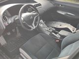 a picture of a car interior with a steering wheel and dashboard