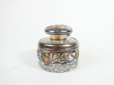 a small glass jar with a lid on a white surface