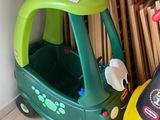 a small toy car and a small toy car in a room