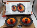 two orange speakers in a cardboard box on a white surface