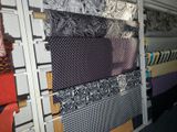 a lot of ties hanging on a rack in a room
