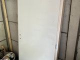 a white door that is next to a pile of junk