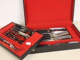 a box with knives and knives in it on a table