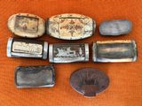 five different types of lighters sitting on a orange cloth