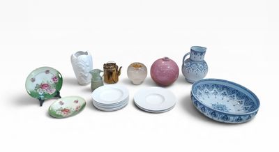 many plates and bowls and vases on the table