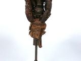 statue d'une femme portant un panier sur la tête, posée sur un socle