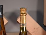 two bottles of wine sitting on a table next to each other