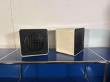 two speakers that are sitting on top of a shelf