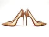 a pair of nude colored high heels on a white background