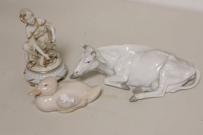 a figurine of a man and a cow on a table