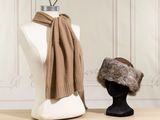 two hats and a scarf on a mannequin head