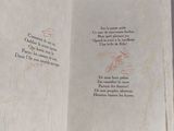 an open book with writing on it sitting on top of a table