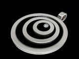 silver plated pendant with a black and white spiral design