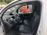 the interior of a car with the door open and the driver ' s seat down