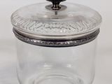an image of a glass jar with a lid on a white surface