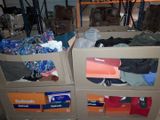 two boxes that have clothes in them in a room