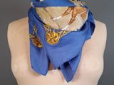 blue scarf with a horse design on it on a mannequin