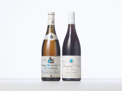 two bottles of wine sitting next to each other on a table
