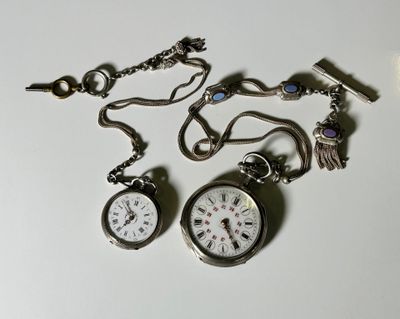 two pocket watches that are sitting on a table