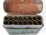 an old metal box with a bunch of empty tubes inside of it