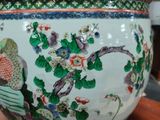 a large vase with a bird on it sitting on a table