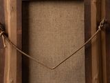 the frame is made of wood and has a rope around it