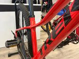 a red bike that is on a stand in a store