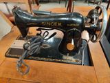 a black sewing machine sitting on a table in a room
