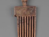 an image of a wooden comb with a wooden handle on a gray background