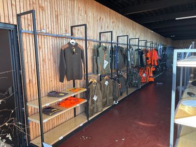 a room filled with lots of clothes and jackets on display