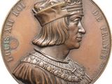 an old bronze medal with a man wearing a crown on it