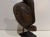 an image of a wooden sculpture of a bird on a stand