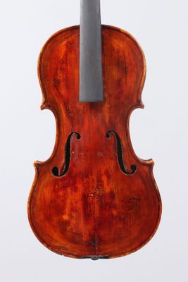 an old violin with a bow hanging from it ' s back