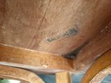 a close up of a wooden chair with writing on it