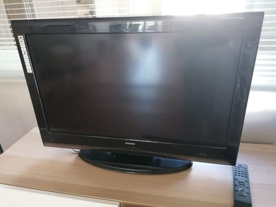 a flat screen tv sitting on top of a wooden table