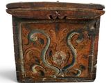 an old wooden box with a design on it