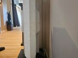 a white sculpture on a black base in a room